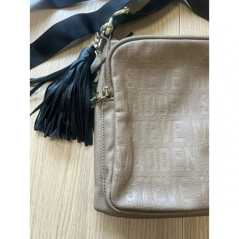 Steve Madden Taupe Embossed Logo Crossbody Bag Tassel Black Strap Gold Hardware